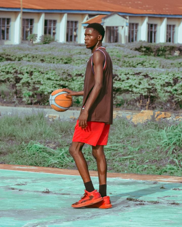 A basketball player on an outdoor court in Nigeria