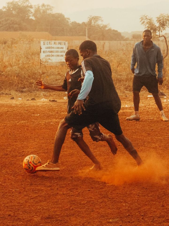 Street football on a dusty pitch